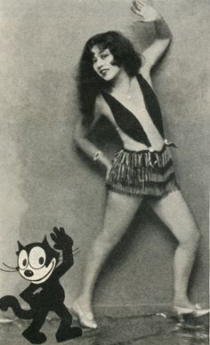 a black and white photo of a woman dancing with a cat in front of her