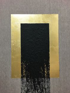 an abstract painting with gold and black paint on grey paper, in the shape of a rectangle