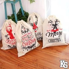 three christmas bags sitting on top of a wooden floor