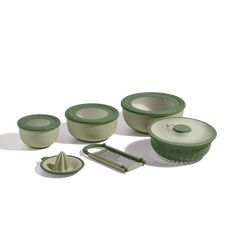 an assortment of green and white kitchen ware