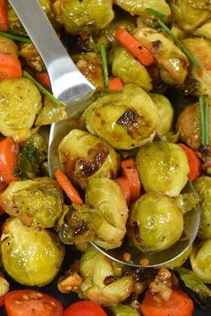 brussel sprouts with carrots and onions in a serving spoon on a plate