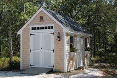 a small wooden shed sitting in the woods