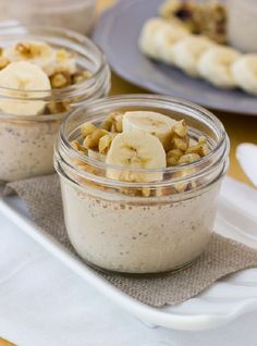 two jars filled with food sitting on top of a table