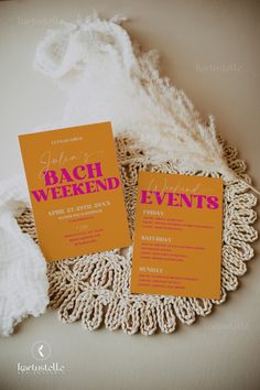 two orange and pink wedding cards on a doily