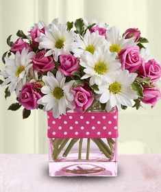 a vase filled with pink and white flowers