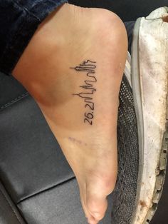 a woman's foot with the word love written in cursive writing on it