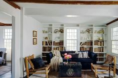 a living room filled with furniture and bookshelves