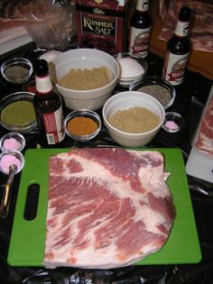 raw meat on cutting board surrounded by spices and seasonings