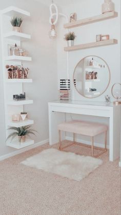 a white desk with a mirror and shelfs on the wall above it in a bedroom