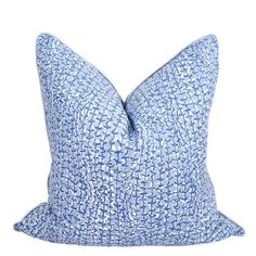 a blue and white pillow on a white background