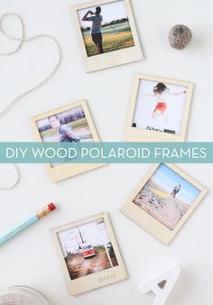 several polaroid frames are hanging on the wall next to a roll of tape and a crayon pencil