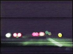 blurry photograph of traffic lights at night