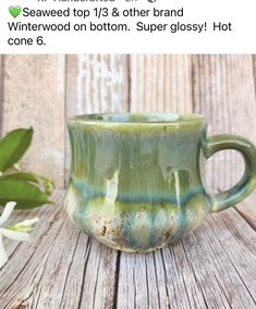 a green cup sitting on top of a wooden table