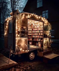 a book truck is decorated with christmas lights and books