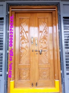 a wooden door with ornate carvings on the side and yellow trim around the bottom part