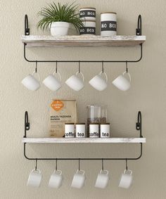 two shelves with coffee mugs and cups hanging from the hooks on each shelf above them