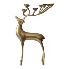 a brass deer statue with three candles on it