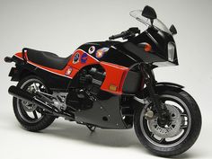 a red and black toy motorcycle on a white background