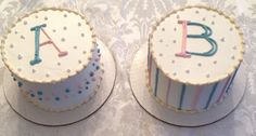 two cakes with letters on them sitting on a table