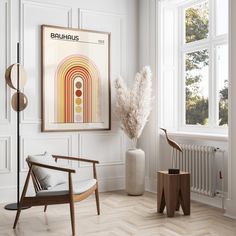 a room with a chair, vase and poster on the wall next to a radiator