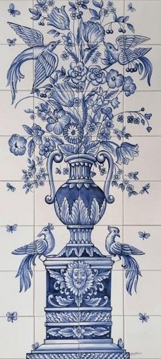 a blue and white tile wall with an ornate vase on it's side, surrounded by birds