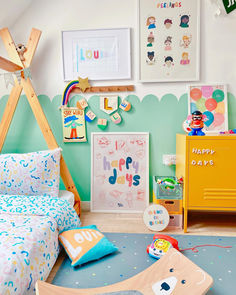 a child's bedroom decorated in blue, green and yellow with toys on the floor