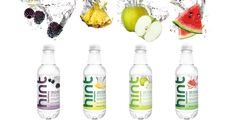 four bottles of juice with fruit and water splashing out the top, on a white background