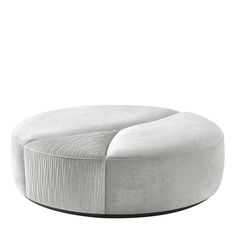 a white round ottoman sitting on top of a wooden table