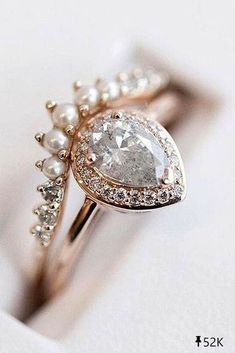 a diamond and pearl ring sitting on top of a piece of paper