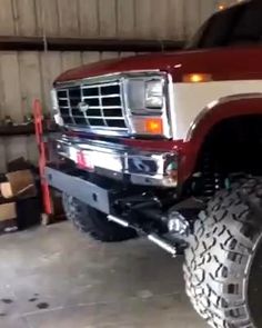 a large red truck parked in a garage