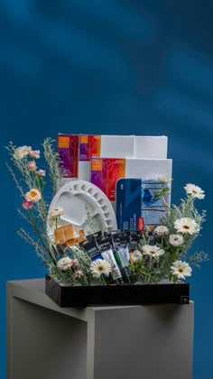 an assortment of items displayed on display in front of a blue background with water and flowers