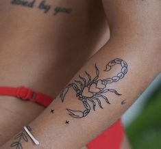 a woman's arm with tattoos on it