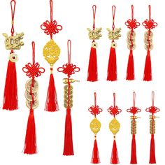 twelve red and gold chinese style ornaments hanging from strings with bows, beads, and bells