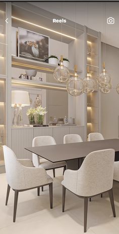 the dining room table is surrounded by white chairs and chandelier with hanging lights