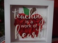 an apple shaped paper art with the words teaching is a work of heart on it