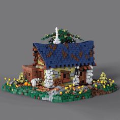 a lego house is shown in the middle of an image with trees and bushes around it