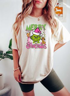 a woman wearing a white shirt with the words merry grouies printed on it