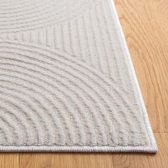 a close up of a rug on the floor with lines and curves in white color