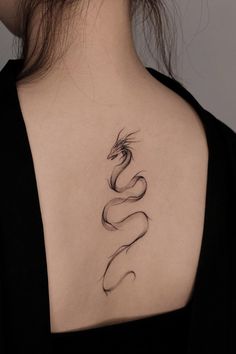 a woman with a snake tattoo on her back