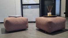 two square foot stools sitting in front of a window