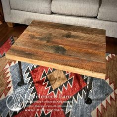 a wooden table sitting on top of a rug next to a couch