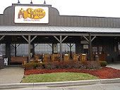 the outside of a restaurant with lots of chairs