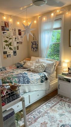 a bed room with a neatly made bed and lots of pictures on the wall above it