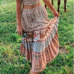 This Boho A-Line Skirt Is Perfect For The Everyday Goddess. This Elastic Waist Skirt Is A Very Versatile Piece That Can Be Worn As A Festival Skirt. Dress It Up With A Crop Top For An Effortless Casual-Chic Look! Ideal For Any Occasion, Or To Give As A Best Friend's Gift, This Unique Boho Skirt Is Truly Something To Behold. Boho Midi Skirt Pull-On Style Stretchy Elastic Drawstring Waist Finished With Brass Beads Relaxed Ruffle Hem Lightweight, Flowy Fabric Measurements Are Approximate: Size Smal Look Hippie Chic, Hippie Rock, Long Skirt Casual, Rayon Skirt, Holiday Skirts, Hippie Skirts, Harvest Gold, Bohemian Skirt, Maxi Skirt Boho