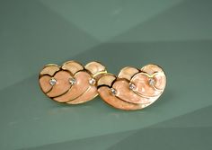 They feature intricate gold plated peach enamel clip on earrings.  KJL Kenneth Jay Lane for Avon from the 1960s or 70s.  They measure 1 1/8' long by just over 5/8" wide. One earring weighs 0.2 oz. From the 1960s or 70s. It is vintage item in good condition. We combine shipping.  KENNETH JAY LANE is known as one of the most prestigious jewelry designer in the U.S. and is a collection of fashion jewelry with extraordinary detail.   Thank You for visiting our Etsy store https://www.etsy.com/shop/Vi Kenneth Jay Lane, Enamel Earrings, Butterfly Wings, Clip On Earrings, Etsy Store, Vintage Items, Fashion Jewelry, Jewelry Design, Jewelry Earrings