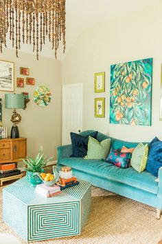 a living room filled with furniture and pictures on the wall above it's coffee table