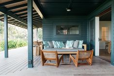 a couch sitting on top of a wooden porch