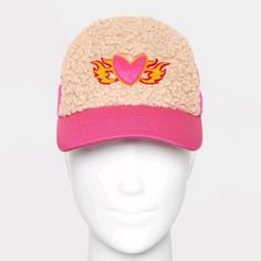 a white mannequin head wearing a pink hat with hearts and wings on it