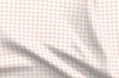 a close up view of a pink and white checkered shirting material with the fabric pulled down