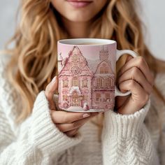 a woman holding a pink coffee mug in her hands